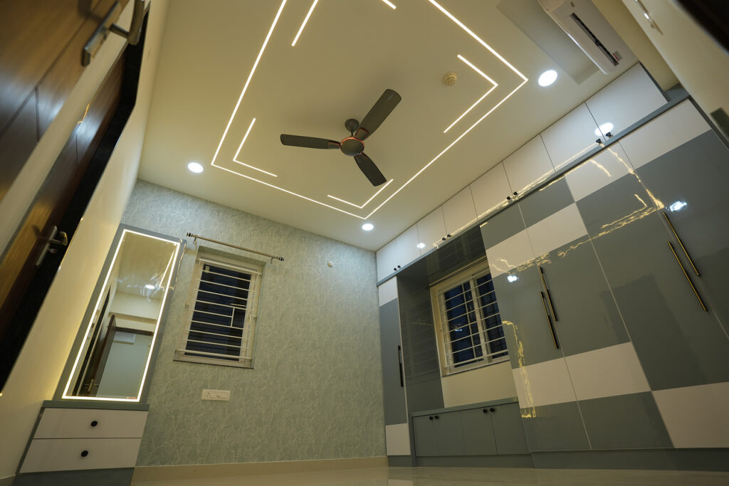 Bedroom wardrobe and vanity unit with ceiling lighting for a Hyderabad home