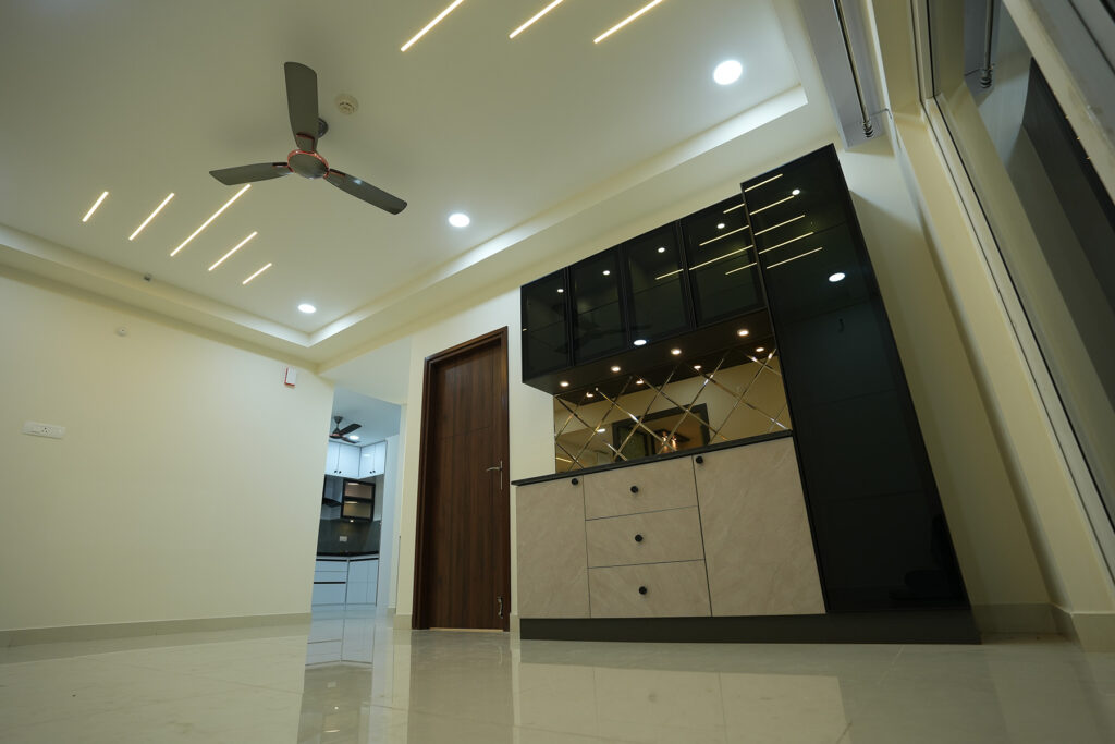 Custom living room storage unit with mirror panel designed by IWY Designs Hyderabad