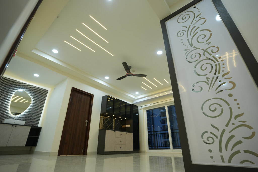Decorative partition, custom storage and ceiling lighting in a Hyderabad apartment interior