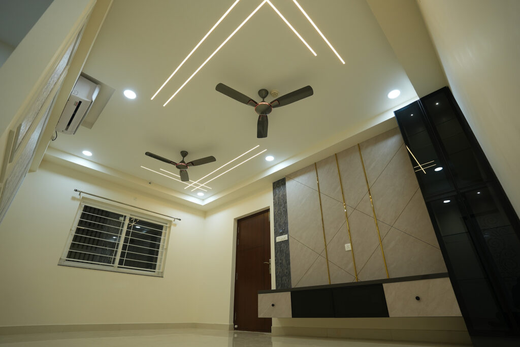 Decorative partition, custom storage and ceiling lighting in a Hyderabad apartment interior