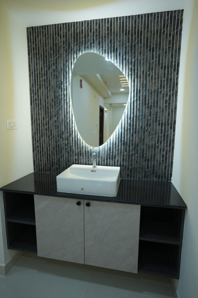 Backlit vanity mirror and fluted wall panel designed by IWY Designs for a Hyderabad residence