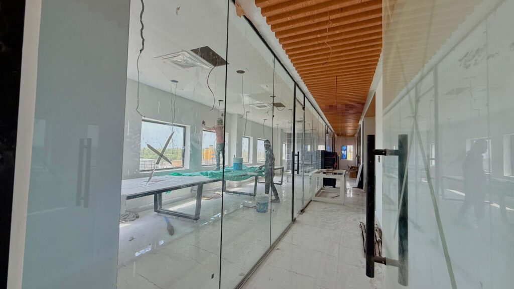 Lab glass cabin and corridor with wood ceiling by IWY Designs Hyderabad