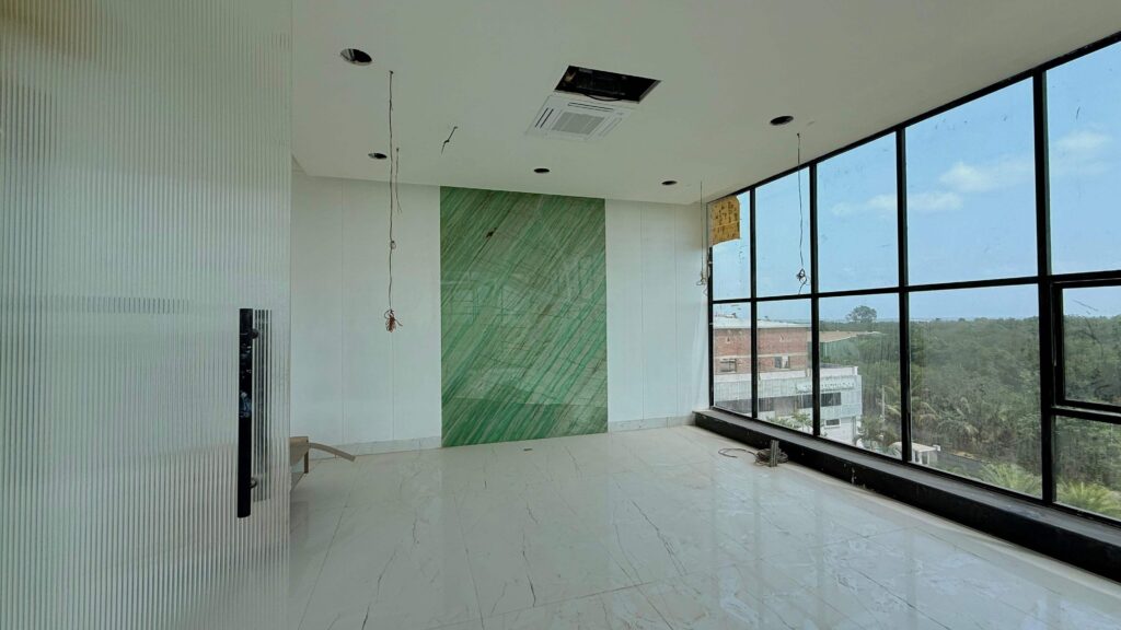 Lab interior with green accent wall and large windows by IWY Designs Hyderabad
