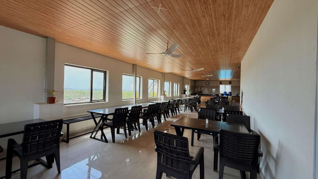 Lab dining room with long seating layout and wood ceiling by IWY Designs
