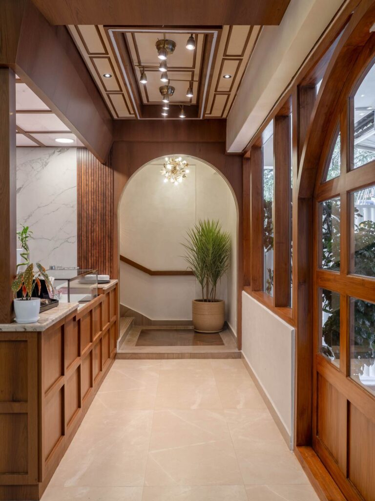 OneTen cafe coffee counter and circulation area with wood finishes by IWY Designs Hyderabad