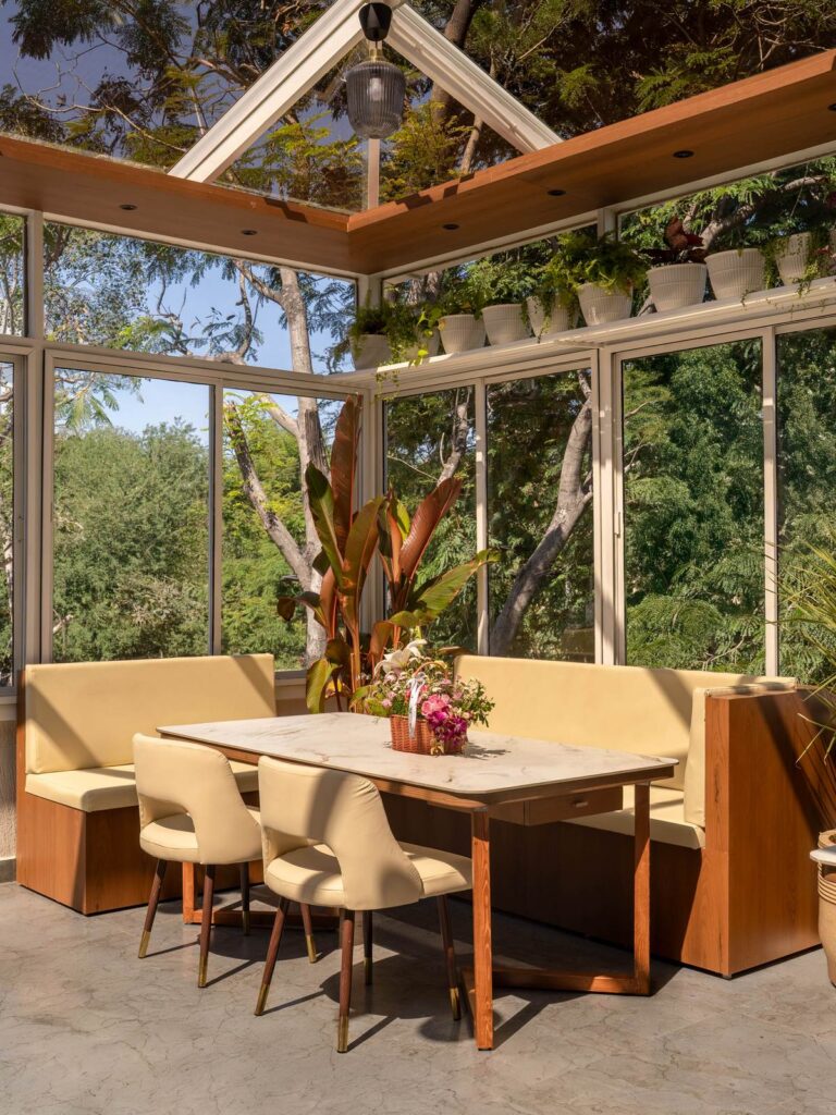 OneTen cafe outdoor pavilion table with glass roof and greenery by IWY Designs Hyderabad