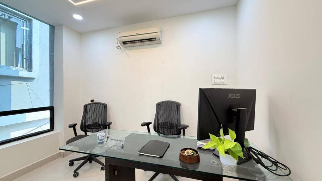 Clinic consultation room with desk layout and natural light by IWY Designs