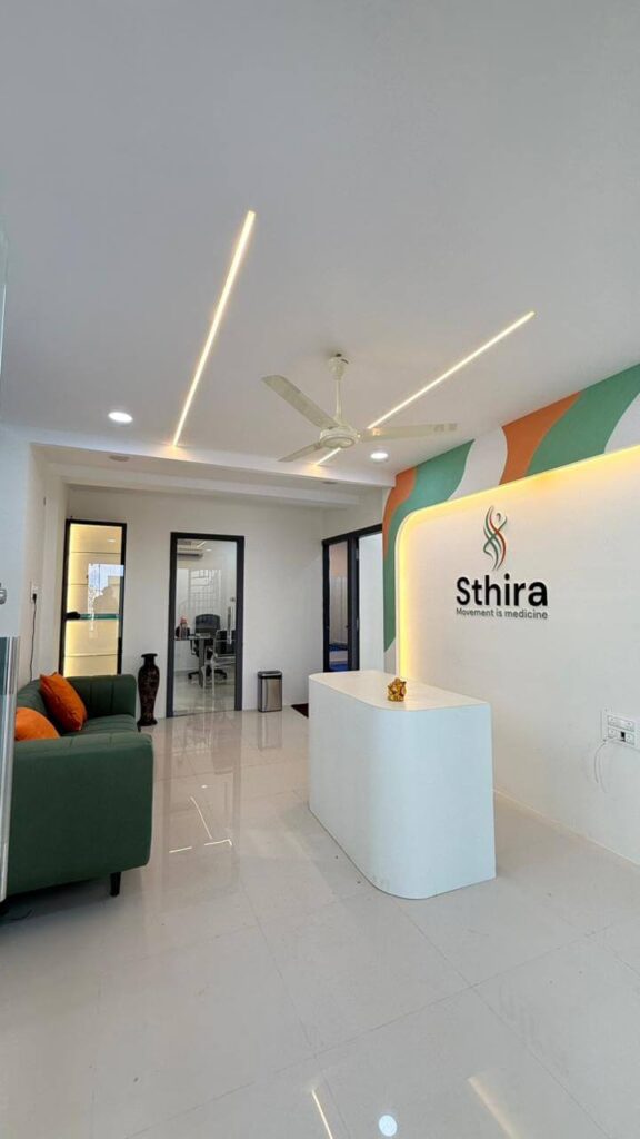 Clinic reception counter with waiting zone and brand wall by IWY Designs Hyderabad